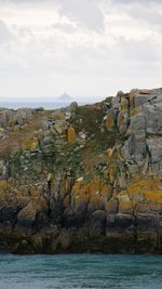 Rock formations by sea against sky - mont saint-michel view