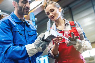 Low angle view of workers working in workshop