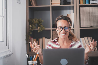 Portrait of smiling woman using mobile phone