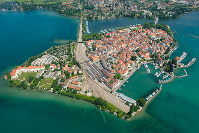 High angle view of cityscape by sea against sky