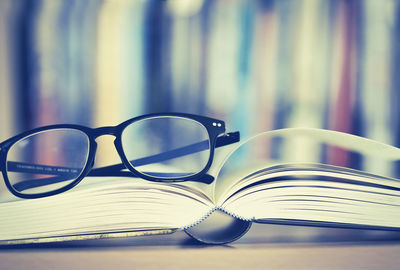 Close-up of book and eyeglasses on table