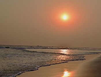 Scenic view of sea against clear sky at sunset