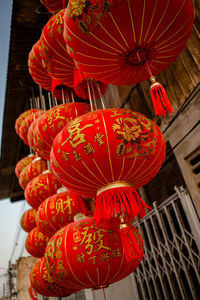 Low angle view of lanterns hanging in traditional building