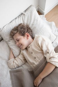 Boy in domestic clothes sweet dreams in natural linens.