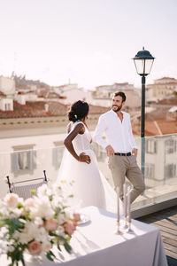 People standing on flowering plants