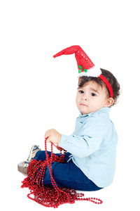 Portrait of cute girl holding toy against white background