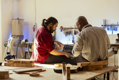 Side view of man working at table