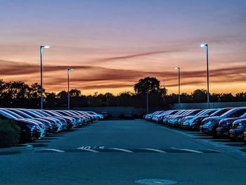 Empty road against blue sky at sunset