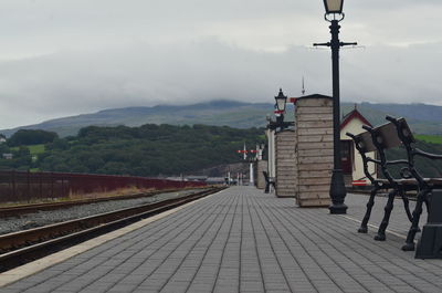 Railroad tracks by buildings against sky