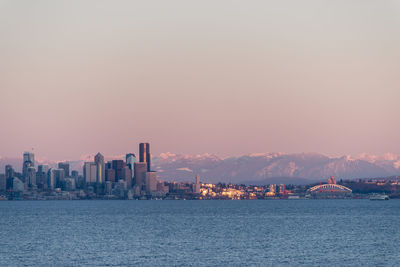 City at waterfront during sunset