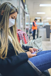 Portrait of young woman using phone