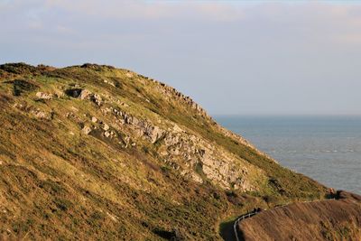 Scenic view of sea and mountains against sky