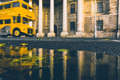 Reflection of building in puddle