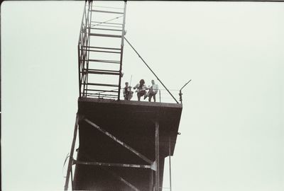 Low angle view of people against clear sky