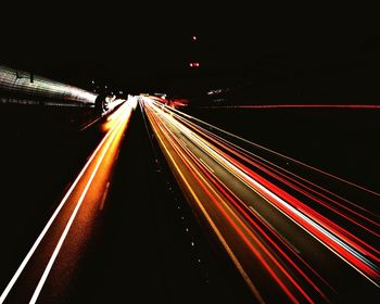 Light trails on road in city at night