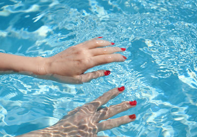 Low section of woman feet in swimming pool