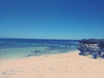 Scenic view of sea against clear blue sky during summer