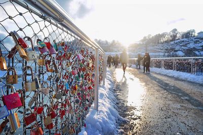 People on snow covered trees against sky