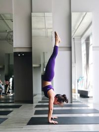 Full length of woman exercising in gym