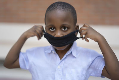 African boy with protective mask to avoid covid19 person