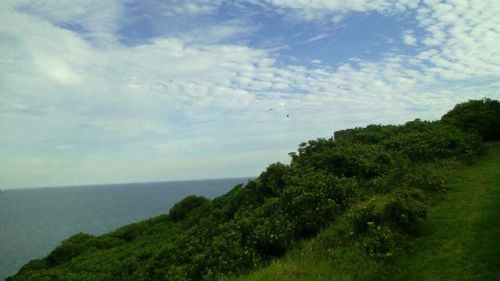 Scenic view of sea against cloudy sky