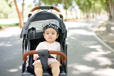 Portrait of cute girl sitting in car