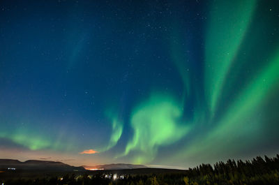 Scenic view of landscape against sky at night