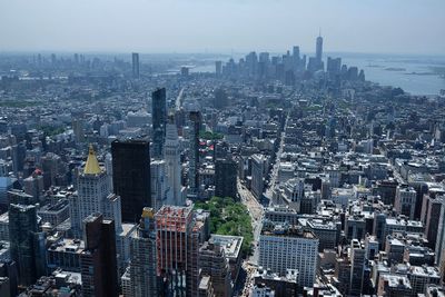 Aerial view of modern buildings in city against sky