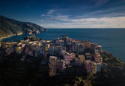 High angle view of townscape by sea against sky