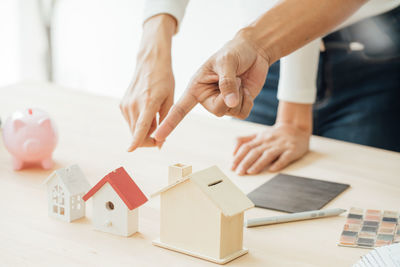 Midsection of people playing with toy on table