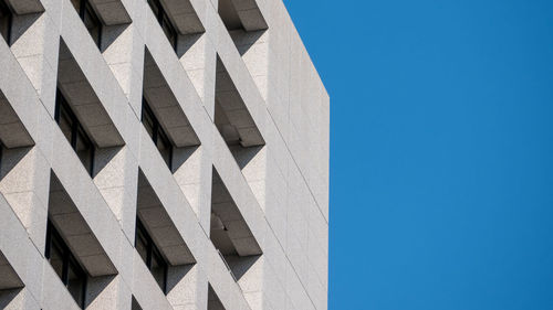 Low angle view of building against clear blue sky