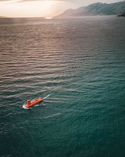 High angle view of submarine in sea during sunset