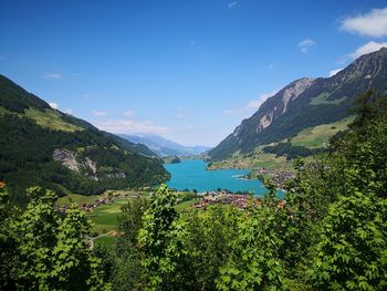 Scenic view of mountains against blue sky