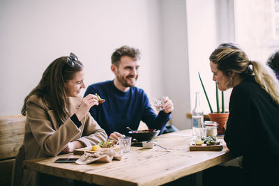Young couple sitting on table