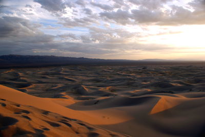 Scenic view of desert against sky during sunset