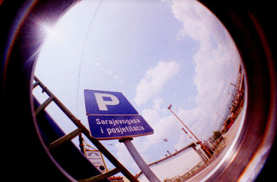 Low angle view of sign board against sky