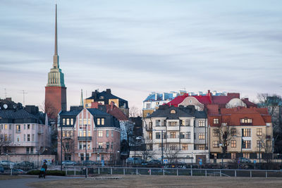 Cityscape against cloudy sky