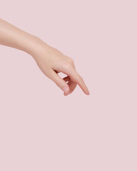 Cropped hand gesturing against white background