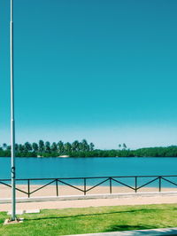 View of calm sea against clear blue sky