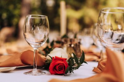 Close-up of rose in glass on table