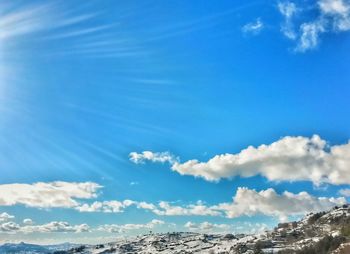 Scenic view of mountains against cloudy sky