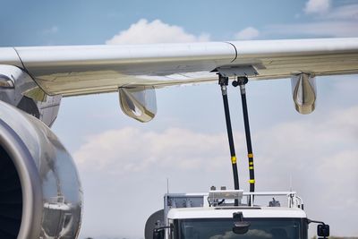 Low angle view of airplane against sky