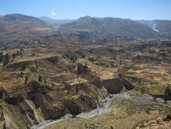 Aerial view of landscape with mountain range in background