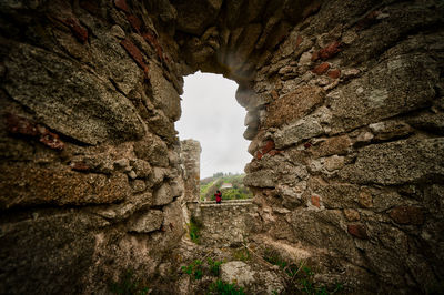 Low angle view of rock formation against sky