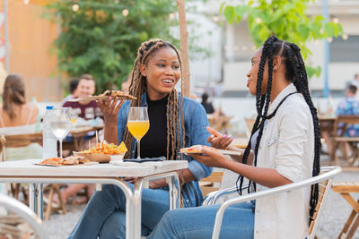 Woman sitting on table at restaurant