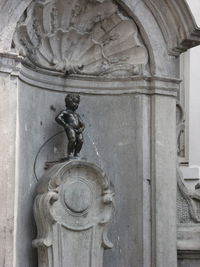 Statue of buddha against building