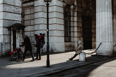 Men on statue in front of building