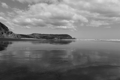 Scenic view of sea against cloudy sky