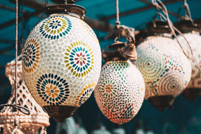 Close-up of decorations hanging for sale in market