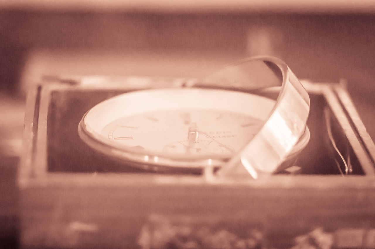 CLOSE-UP OF OLD CLOCK ON TABLE AT HOME